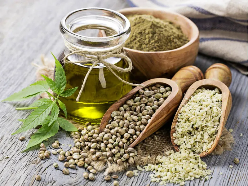 An image showing hemp seeds, a leaf and oil together.