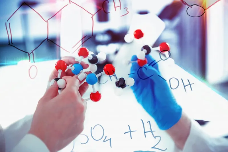 A researcher working on a molecular model in a laboratory.